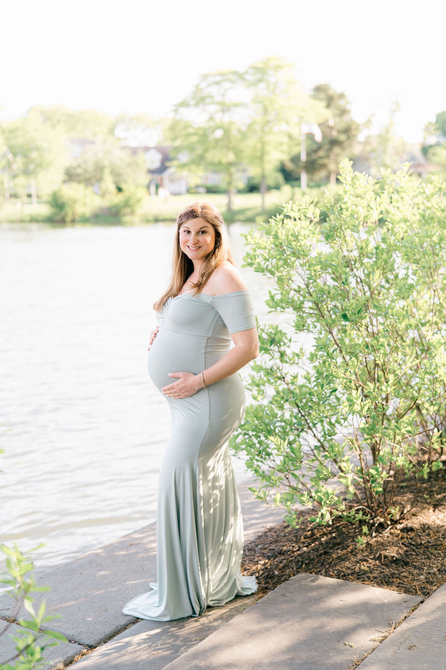 A pregnant lady poses for the camera at divine park in spring lake NJ.