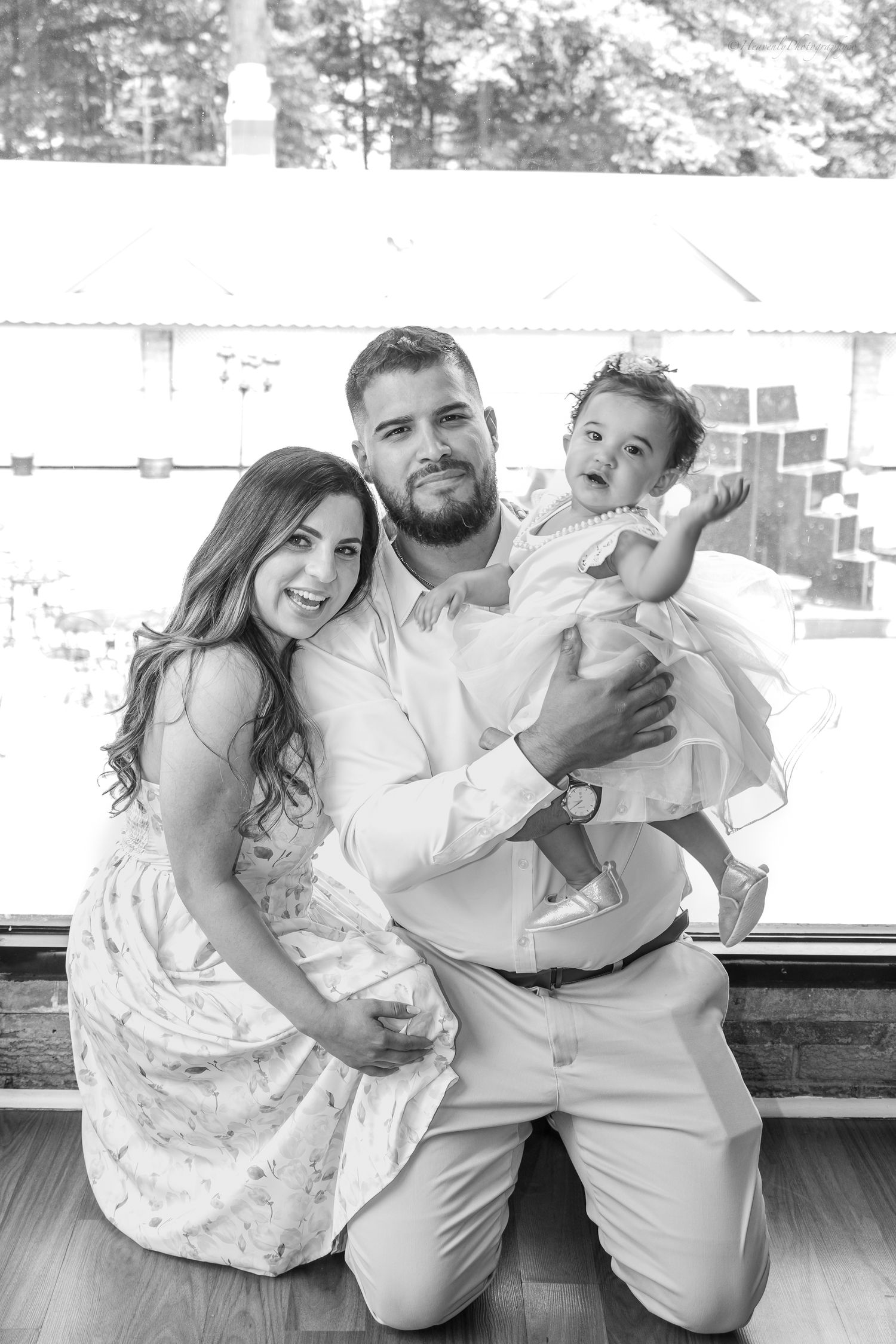Playful family photoshoot with dancing and laughter.