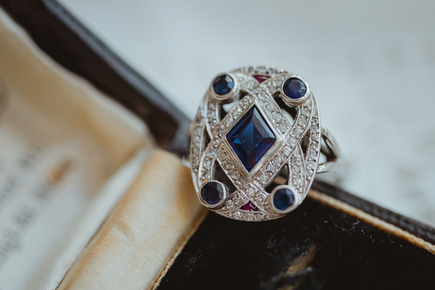 Vintage-style ring featuring blue sapphires and diamonds in an ornate silver setting.
Small Business product photography