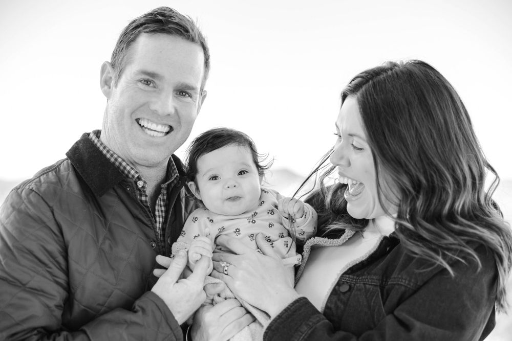 Black and white portrait of family sharing intimate moment.