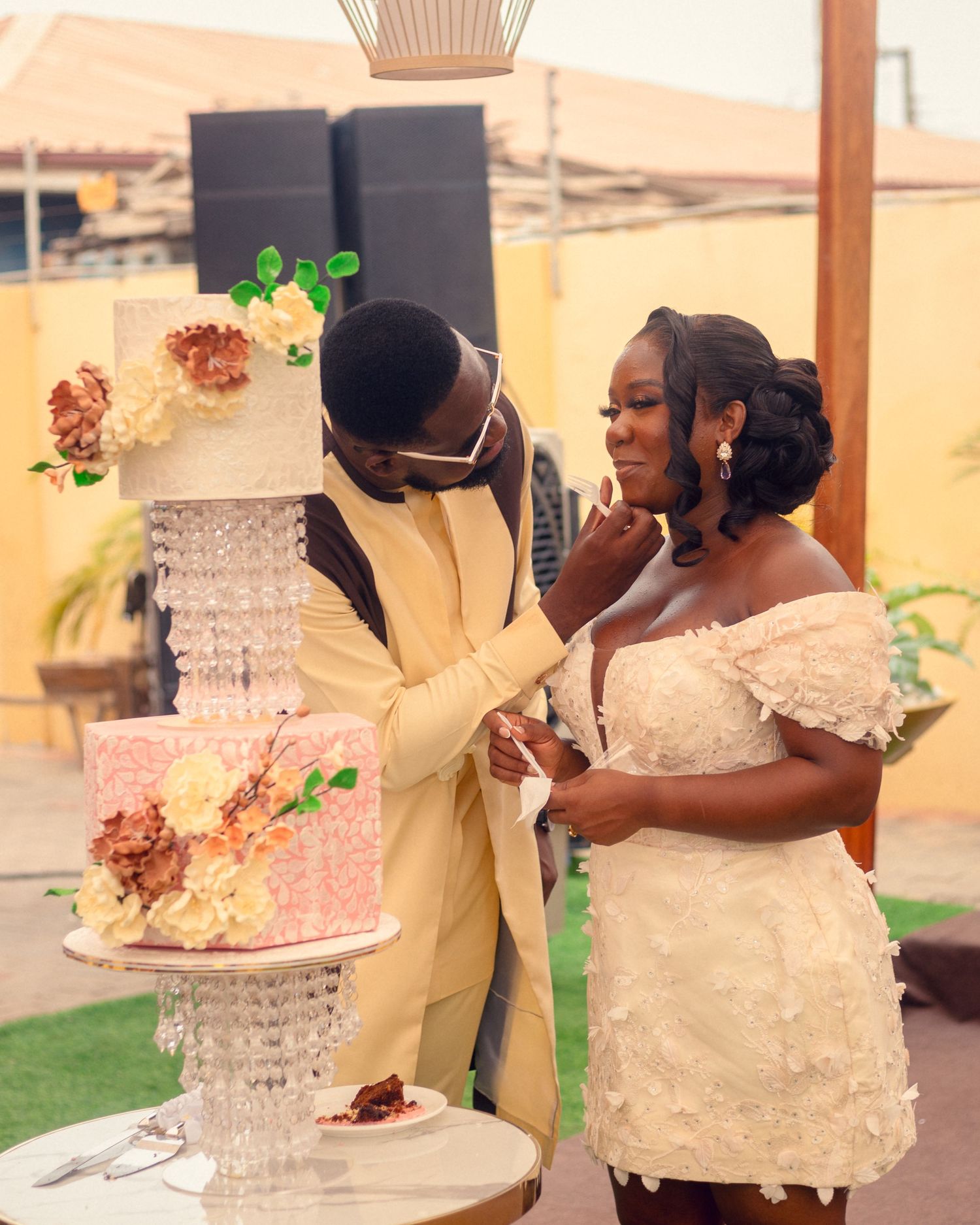 Couple samples wedding cake decorated with crystals and floral accents.