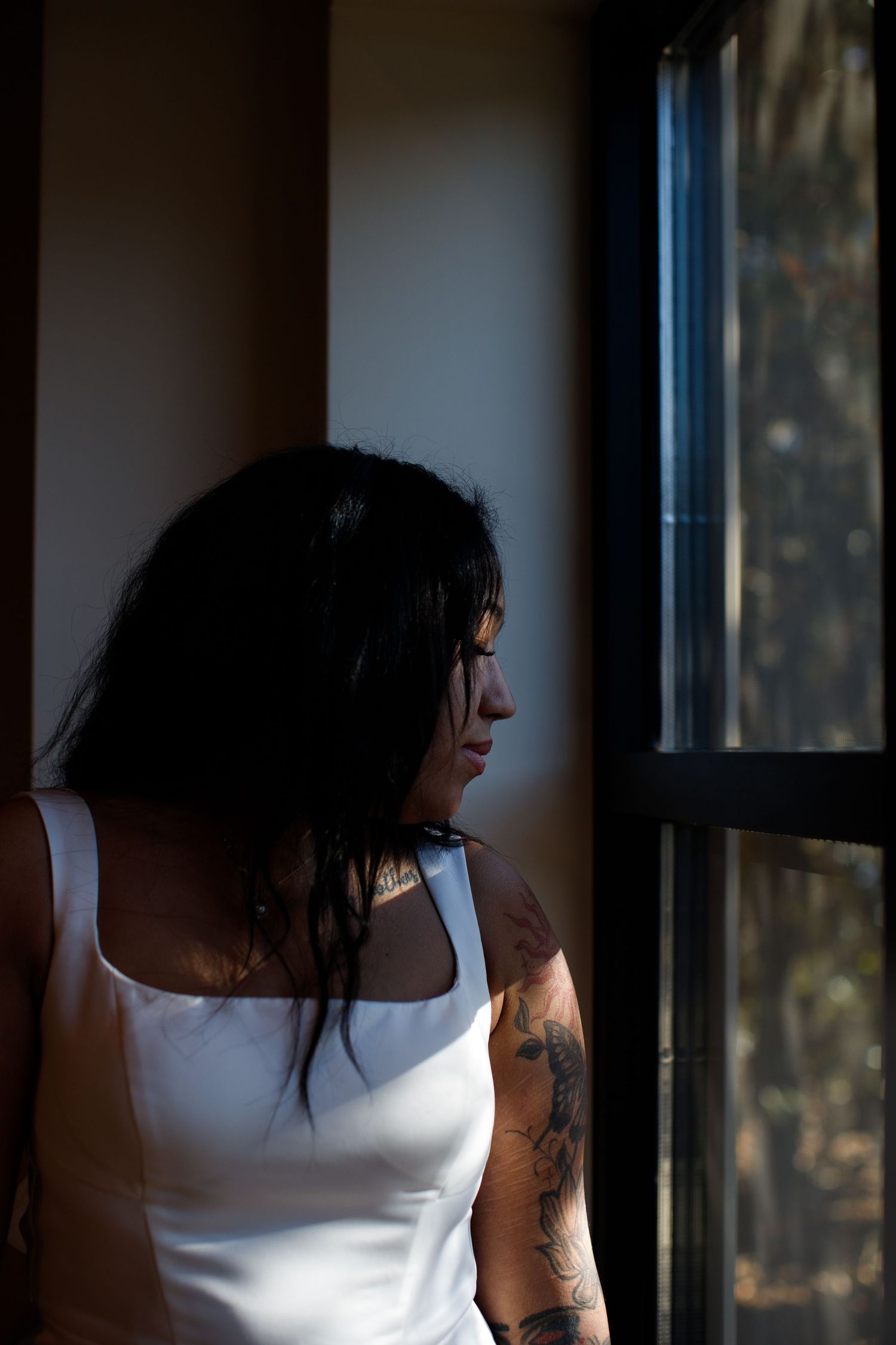 side profile of bride in moody light at wedding