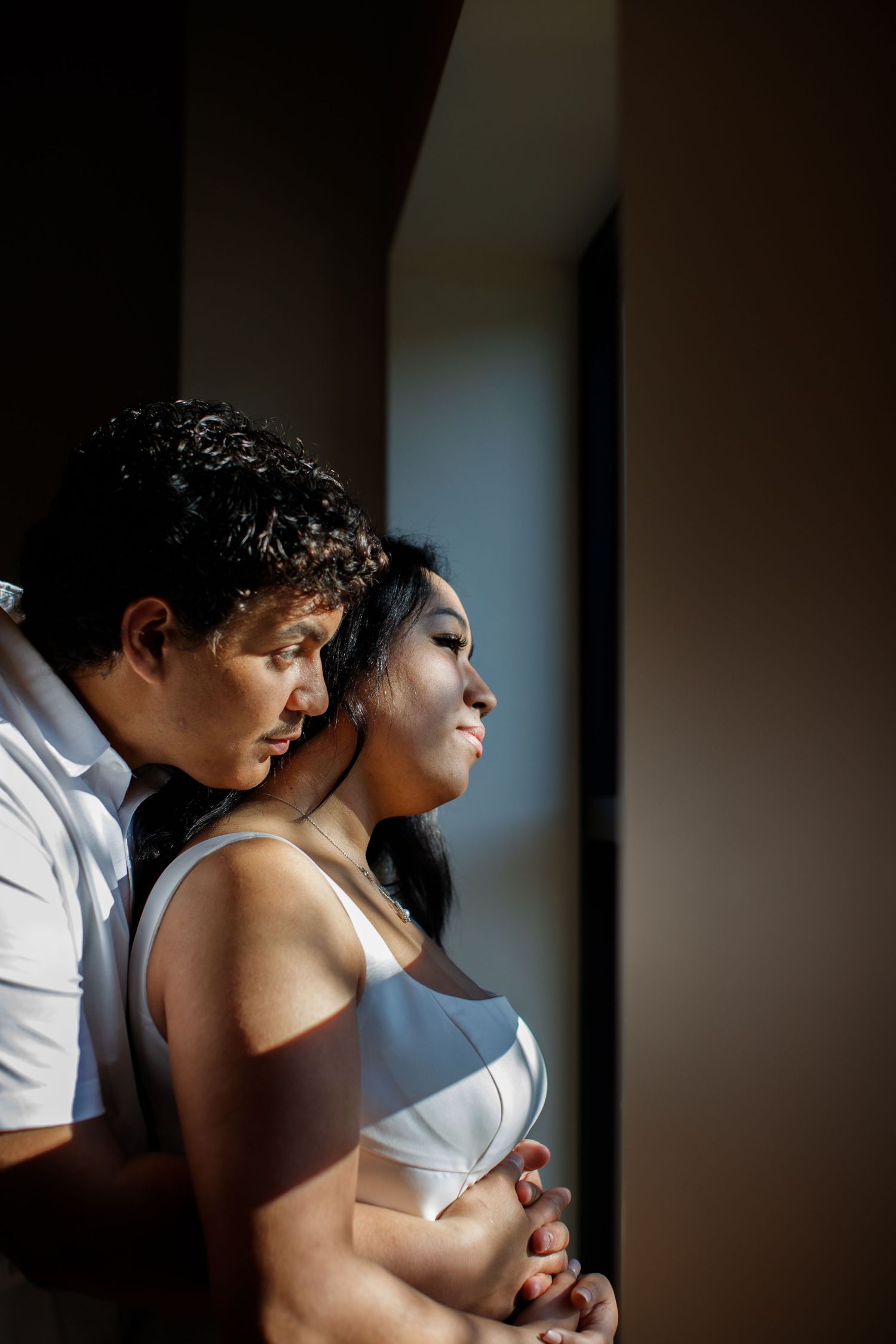 bride and groom poses moody light wedding