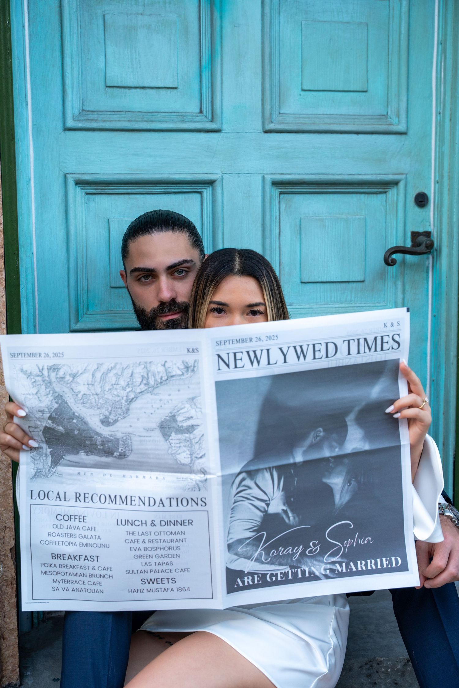 Couple holding a custom 'Newlywed Times' newspaper, adding a fun, creative touch to their engagement photos.