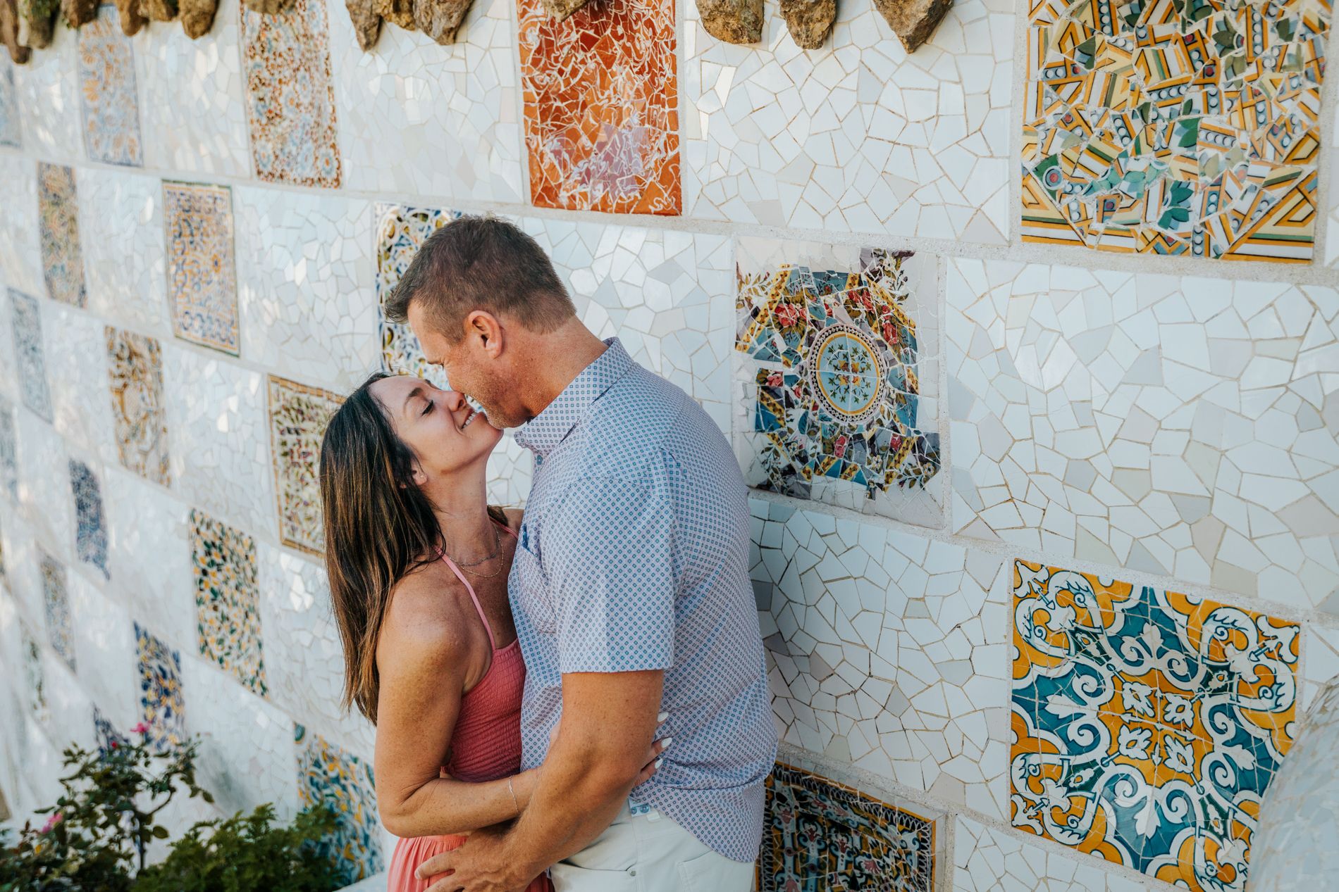 Couple celebrating their 20th wedding anniversary with a romantic photoshoot at Park Güell, Barcelona.