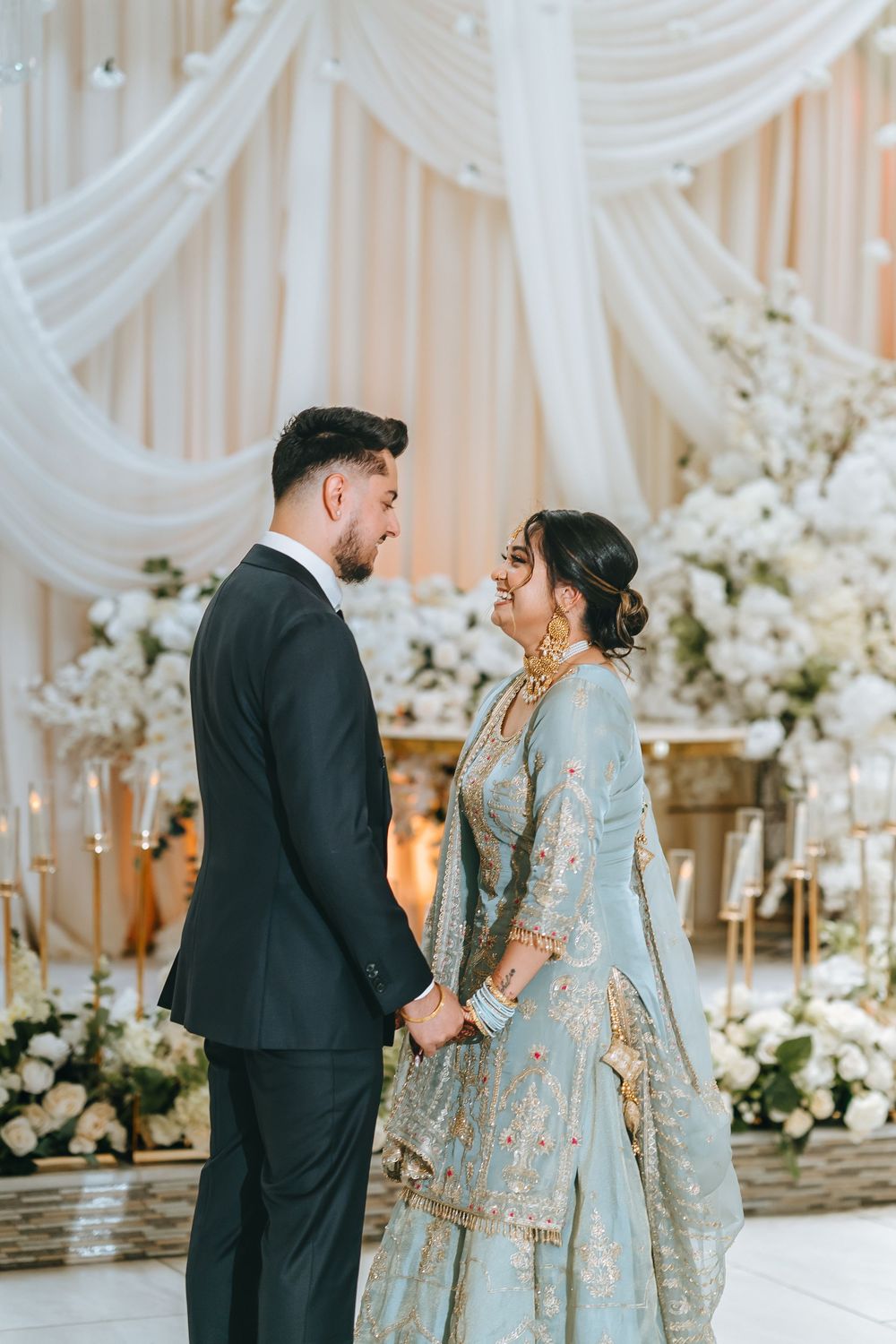 Romantic wedding photo sequence showing a couple interacting in front of white drapes and floral decor.