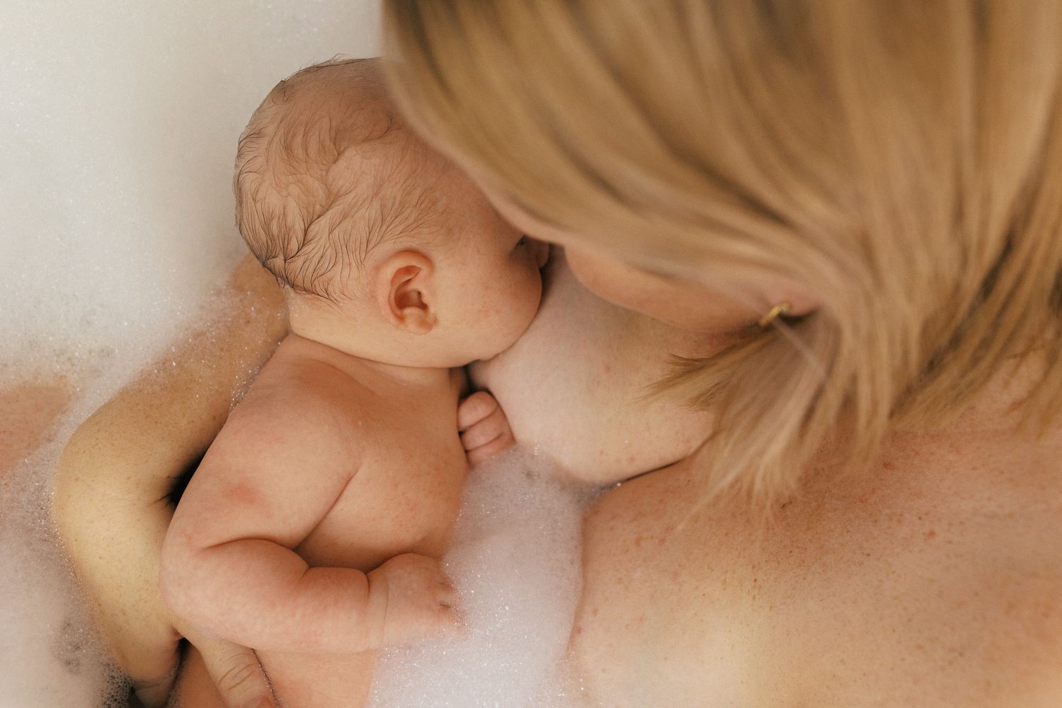Warm-toned photograph showing an intimate bonding moment between parent and child.