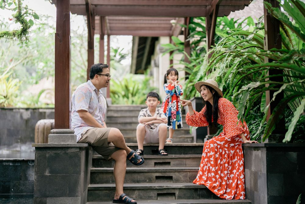 Peaceful gazebo seating area overlooking tropical gardens and rice fields.