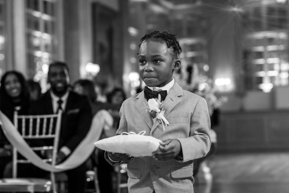 A wedding reception scene shows guests dancing and celebrating in a dimly lit ballroom setting.