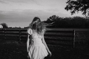 Black and white portrait series showing movement and emotion in outdoor setting.