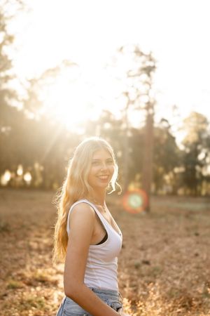 Backlit outdoor portrait session in a natural setting with warm golden hour lighting.