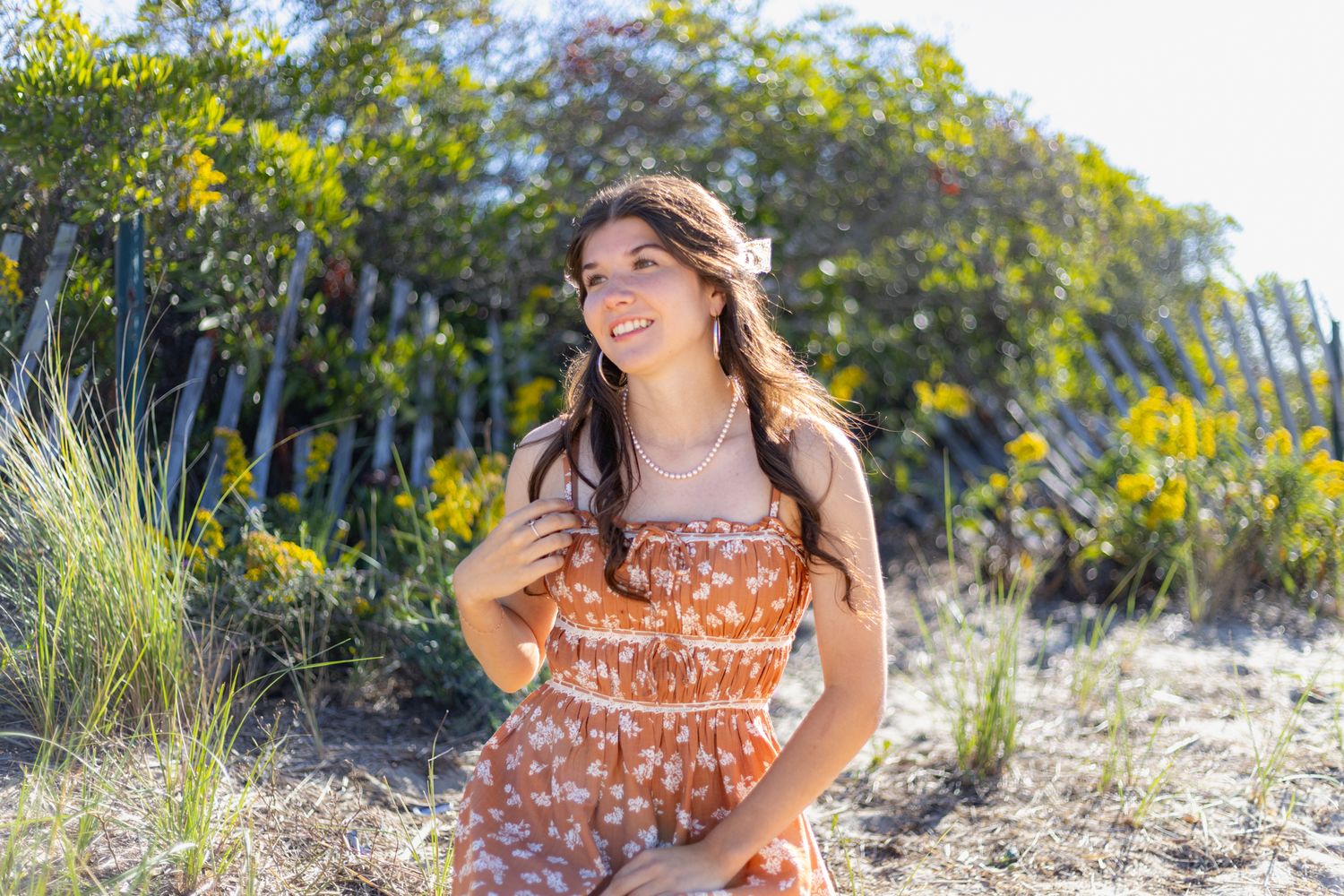 A romantic engagement photo session in a golden marsh field during sunset.