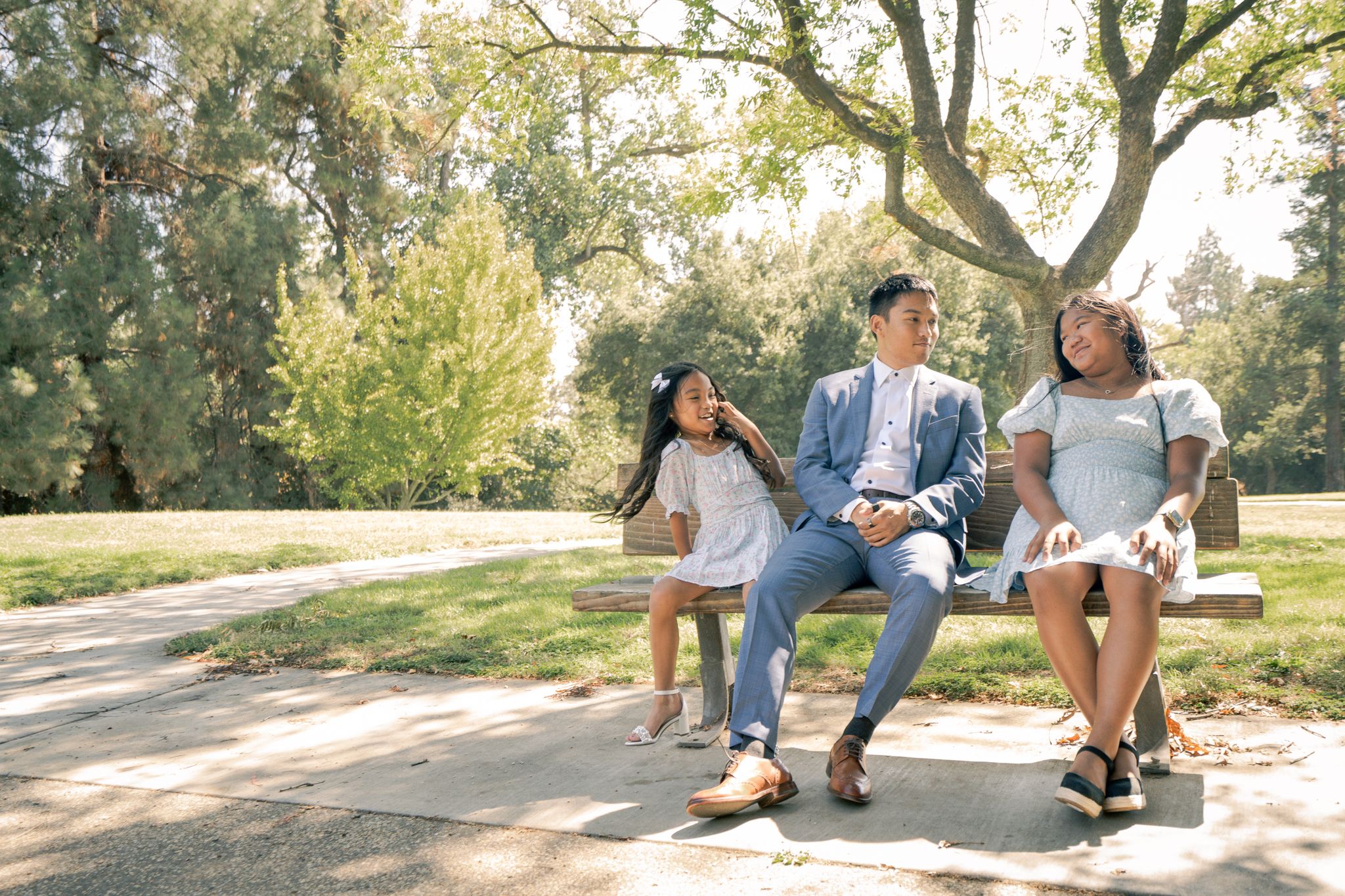 A series of romantic outdoor photos showing a couple enjoying time together in a sunlit park setting.