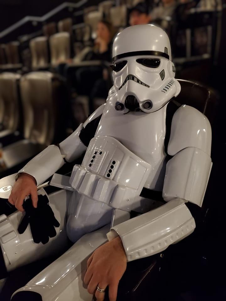 A Stormtrooper from Star Wars sits in a relaxed pose wearing iconic white armor and helmet.