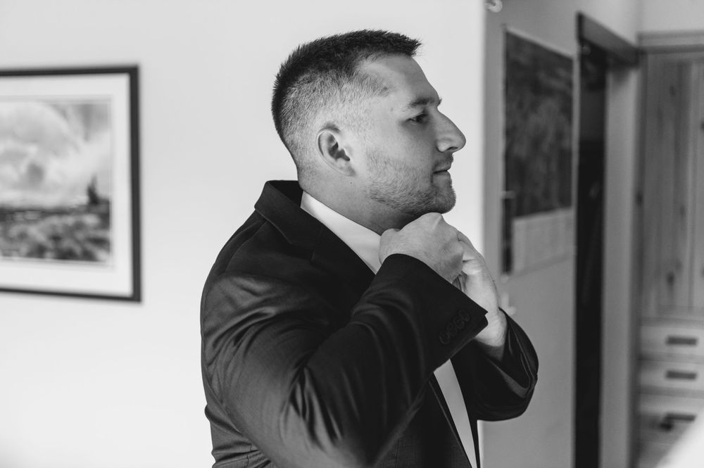 A black and white photo montage shows someone in a suit looking out windows in different poses.