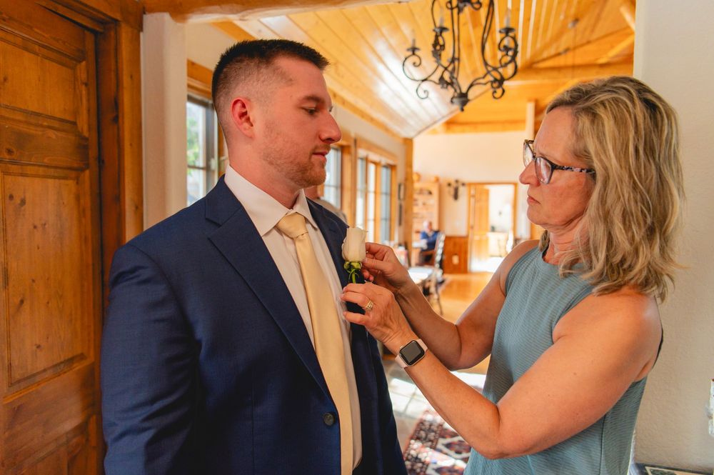 Wedding couple shares intimate moments in a rustic wooden hallway with warm lighting and elegant decor.