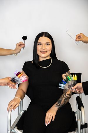 A series of hands showing off colorful nail polish swatches against a white background.