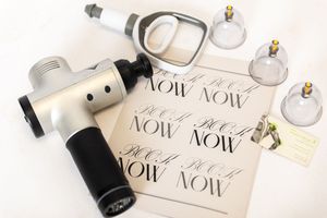 Flatlay photography setup with camera, white earbuds, and handwritten calligraphy notes on a light background.