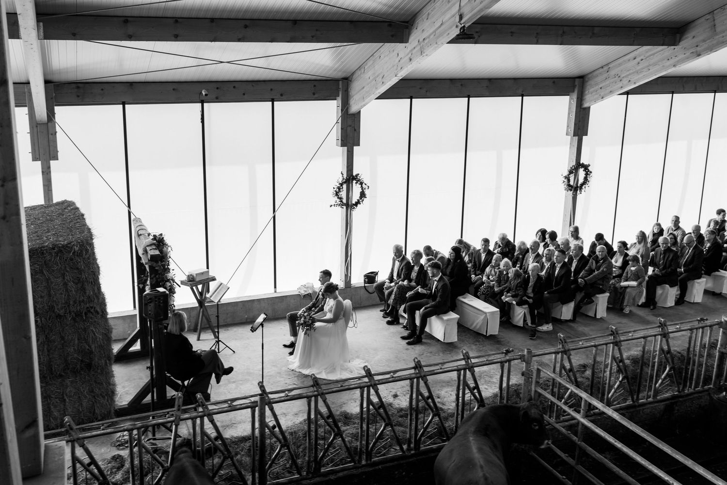Historic black and white panoramic photograph showing a large crowd gathered in a covered observation deck overlooking a city.