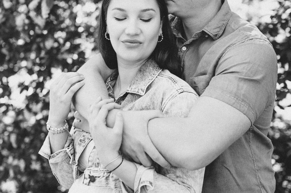 A romantic outdoor photoshoot in a sunlit garden with soft natural lighting.