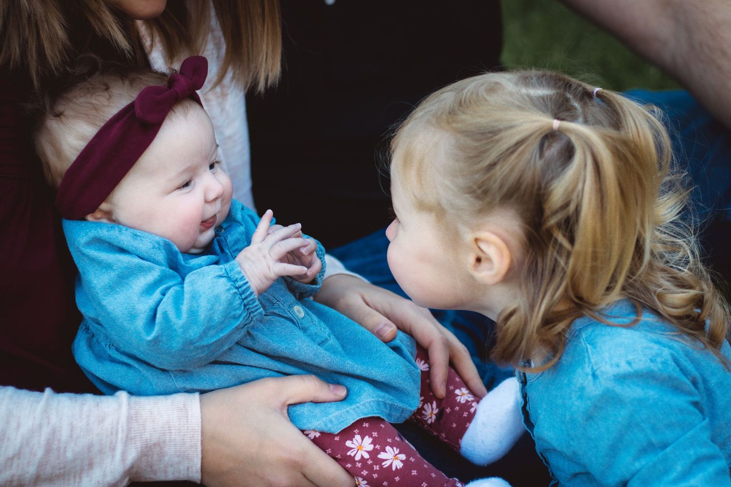 Older sister making baby sister laugh during family photo session, Metro Detroit family photography, Sam Jackson Photography