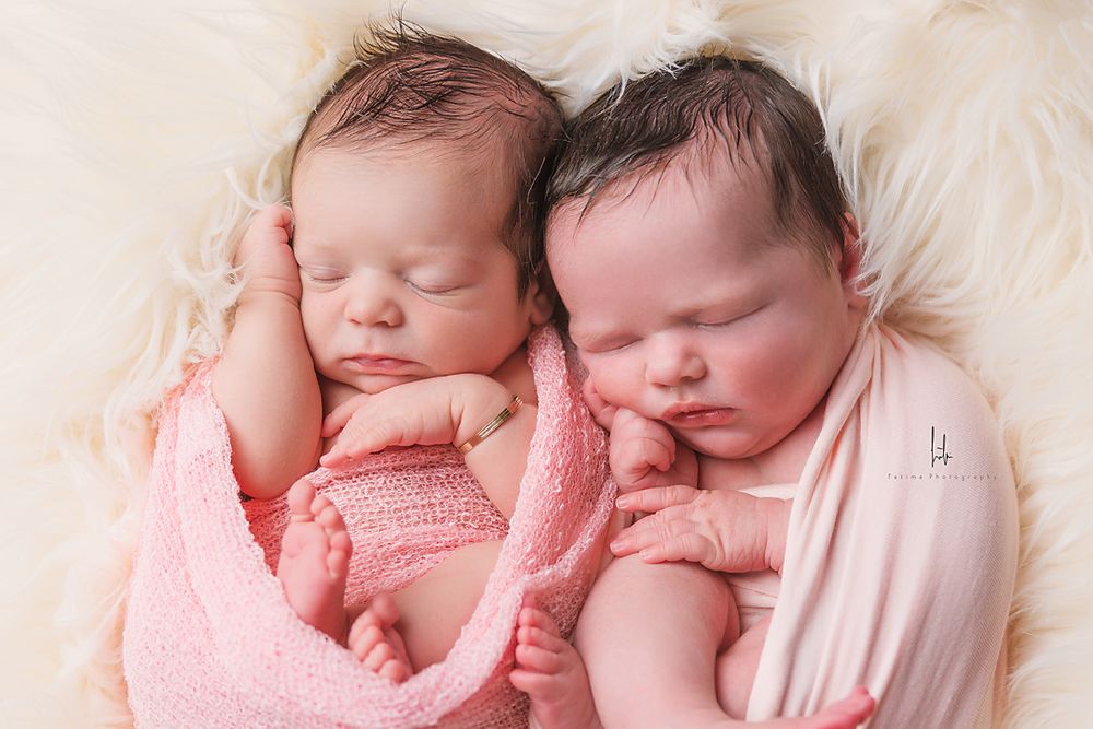 Collage of four peaceful newborn babies sleeping in soft pink and white tones.