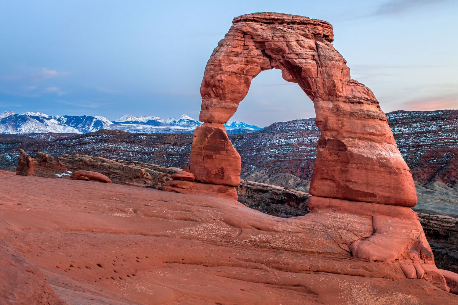 Warm and cold collide in this sunset scene at the Delicate Arch, Arches National Park in Moab, Utah.