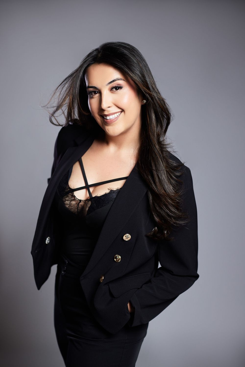 Stylish fashion portraits in black blazer with dramatic lighting and dynamic poses.