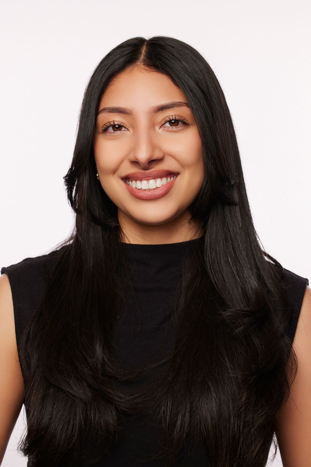 Series of expressive headshots with black turtleneck against white background showing genuine smiles.