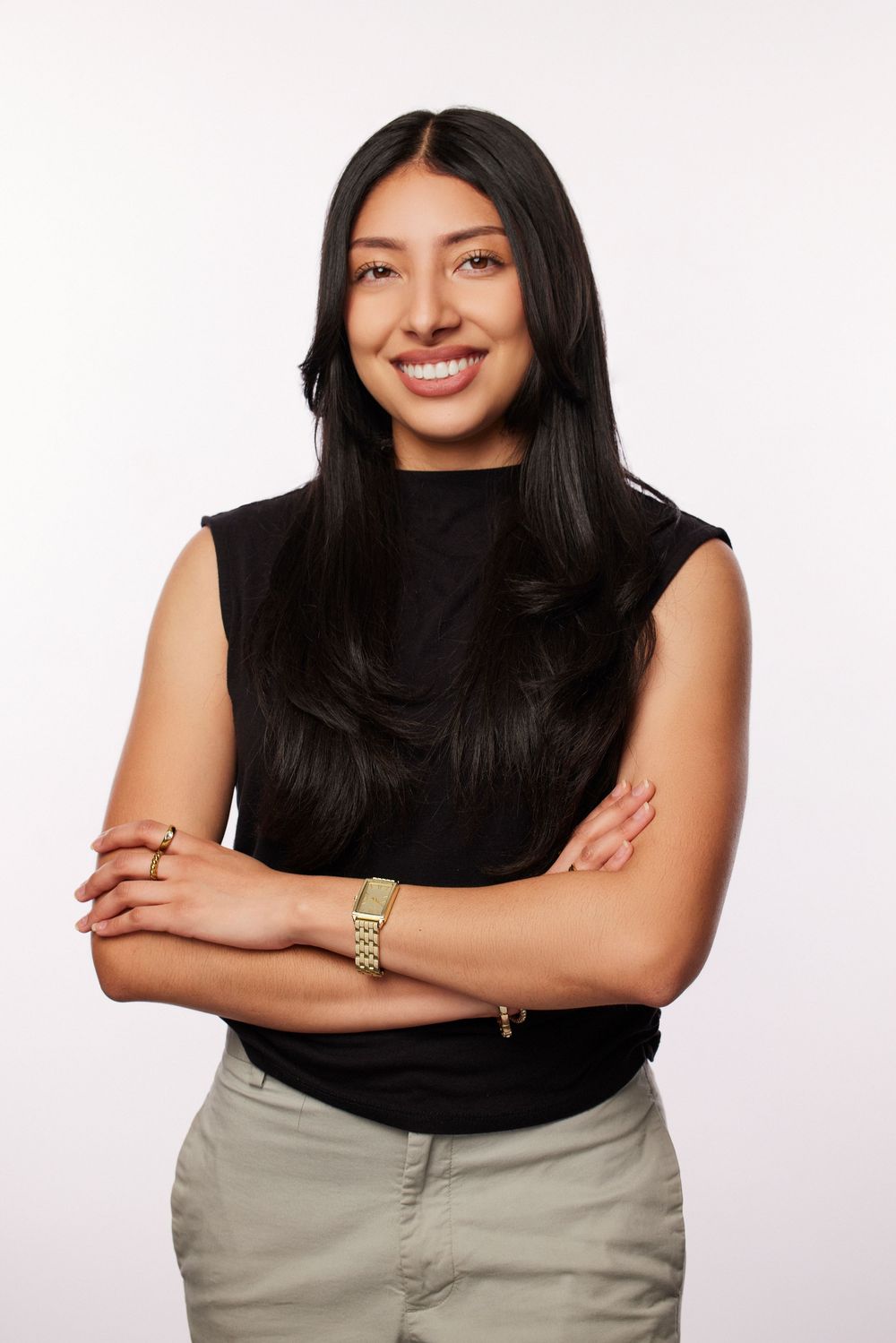 Casual portrait series in black sleeveless top and khaki pants with natural poses.