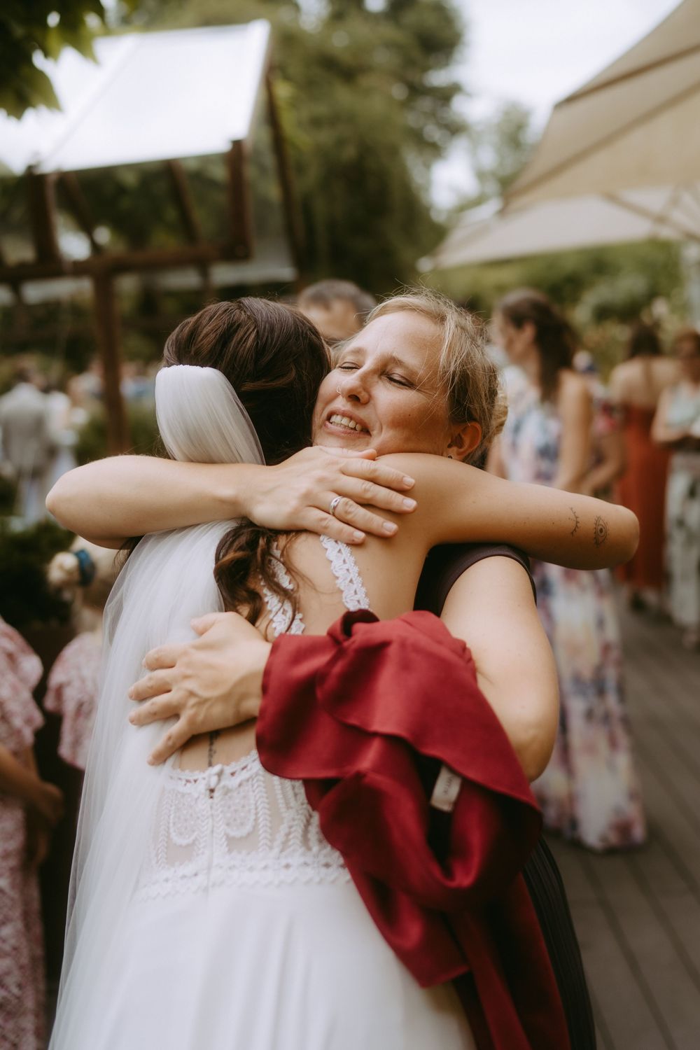 Emotional embraces shared between wedding guests in a heartfelt moment.