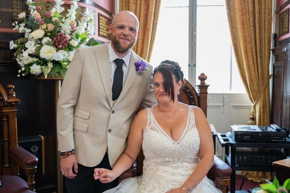 Wedding ceremony in an elegant room with yellow walls and classic decor.