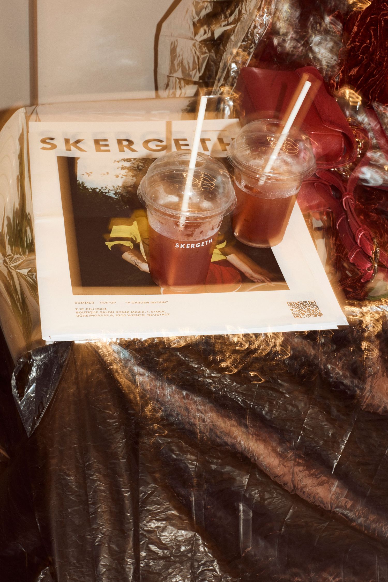 Two iced drinks placed on Skergeth magazine cover at a festive holiday event display.