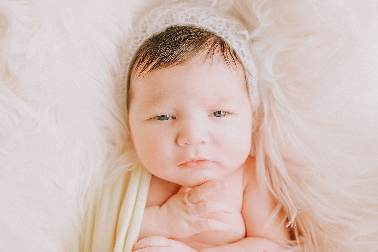 A collection of soft, dreamy baby portraits arranged in a horizontal series with ethereal lighting and white backgrounds.