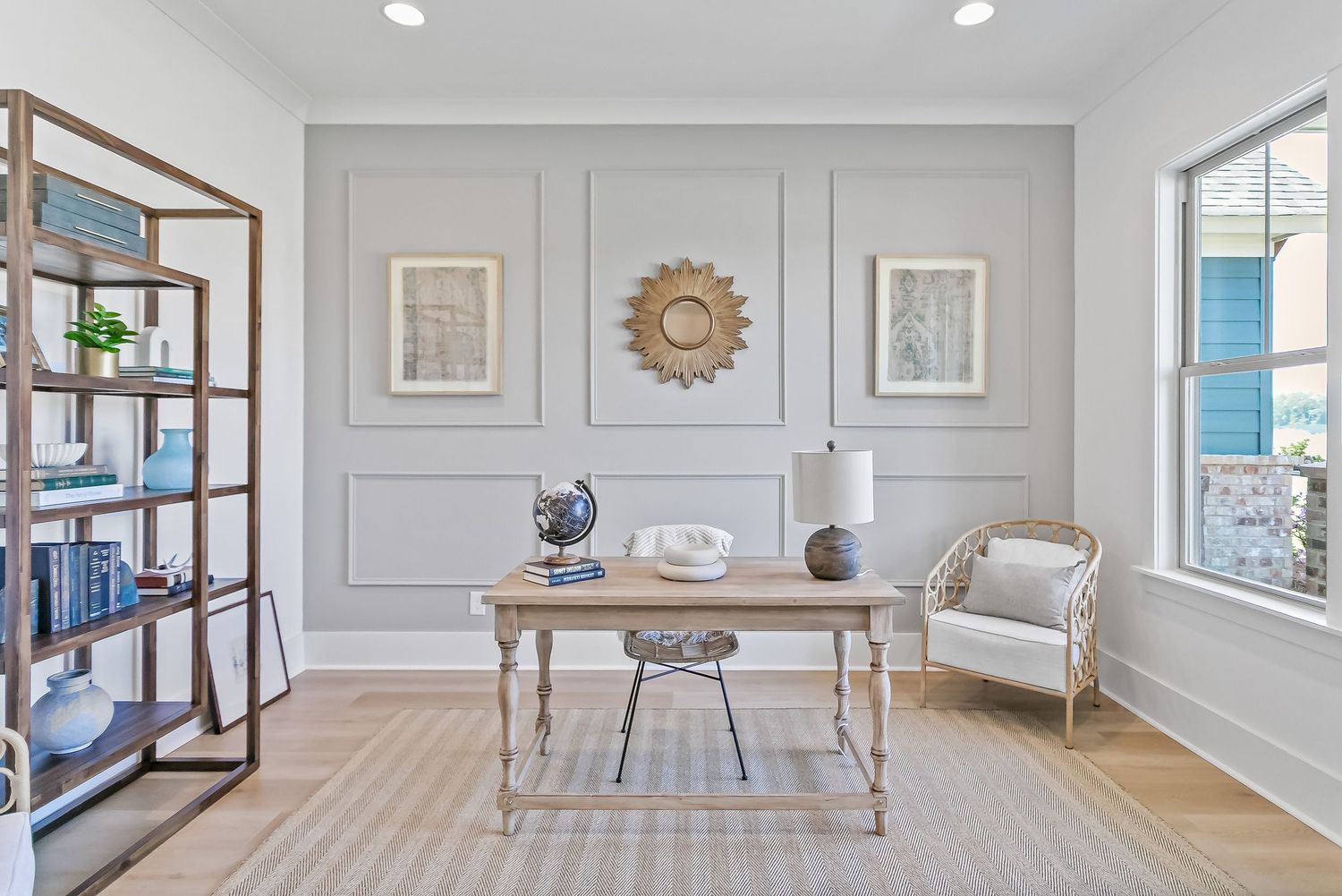 Bright and airy modern living room with white walls, hardwood floors, and elegant crown molding details.