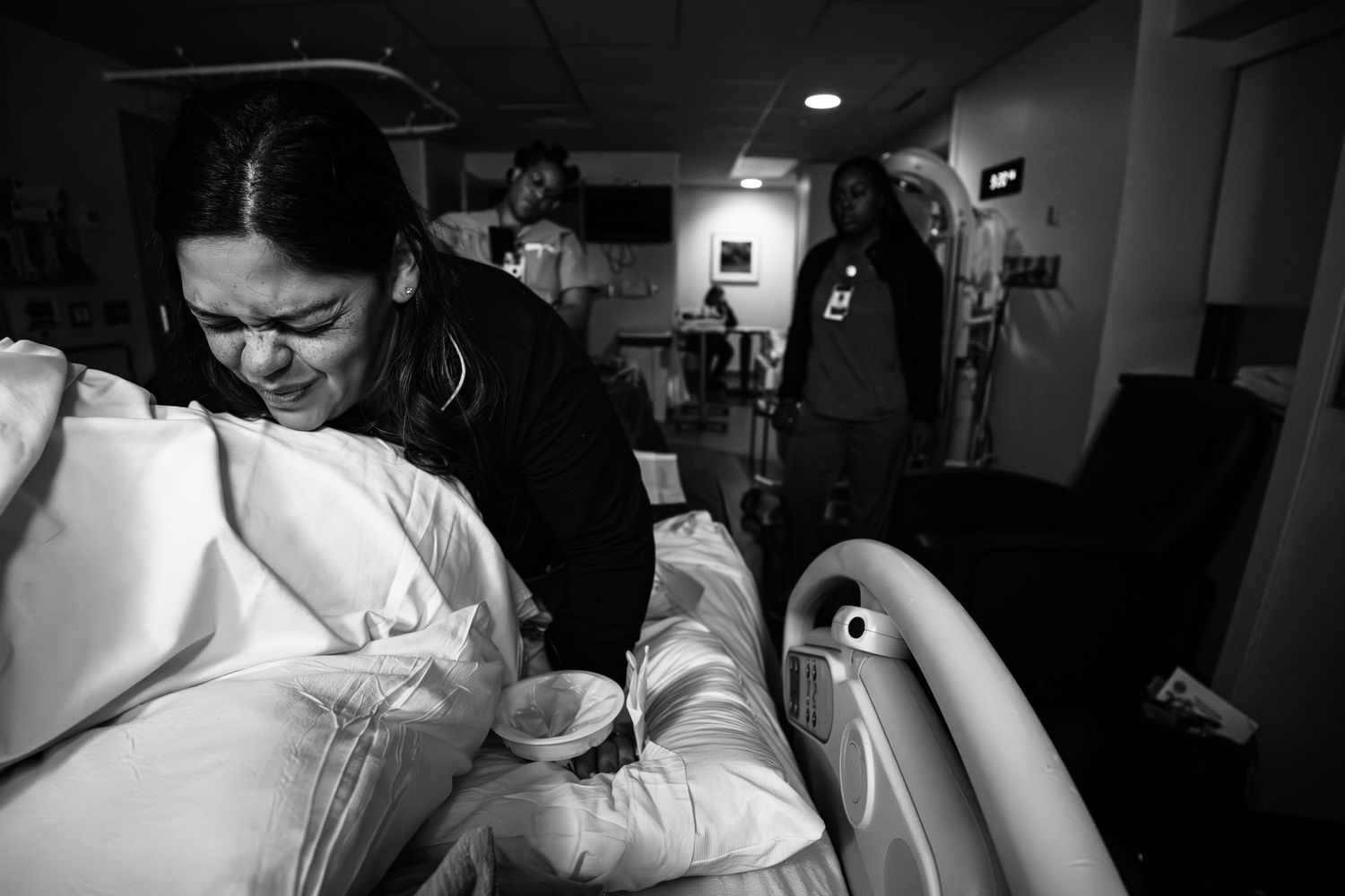A mom having a contraction while she labors at Oschner Baptist hospital in New Orleans. Shot by Autumn Hutton a New Orleans photographer.