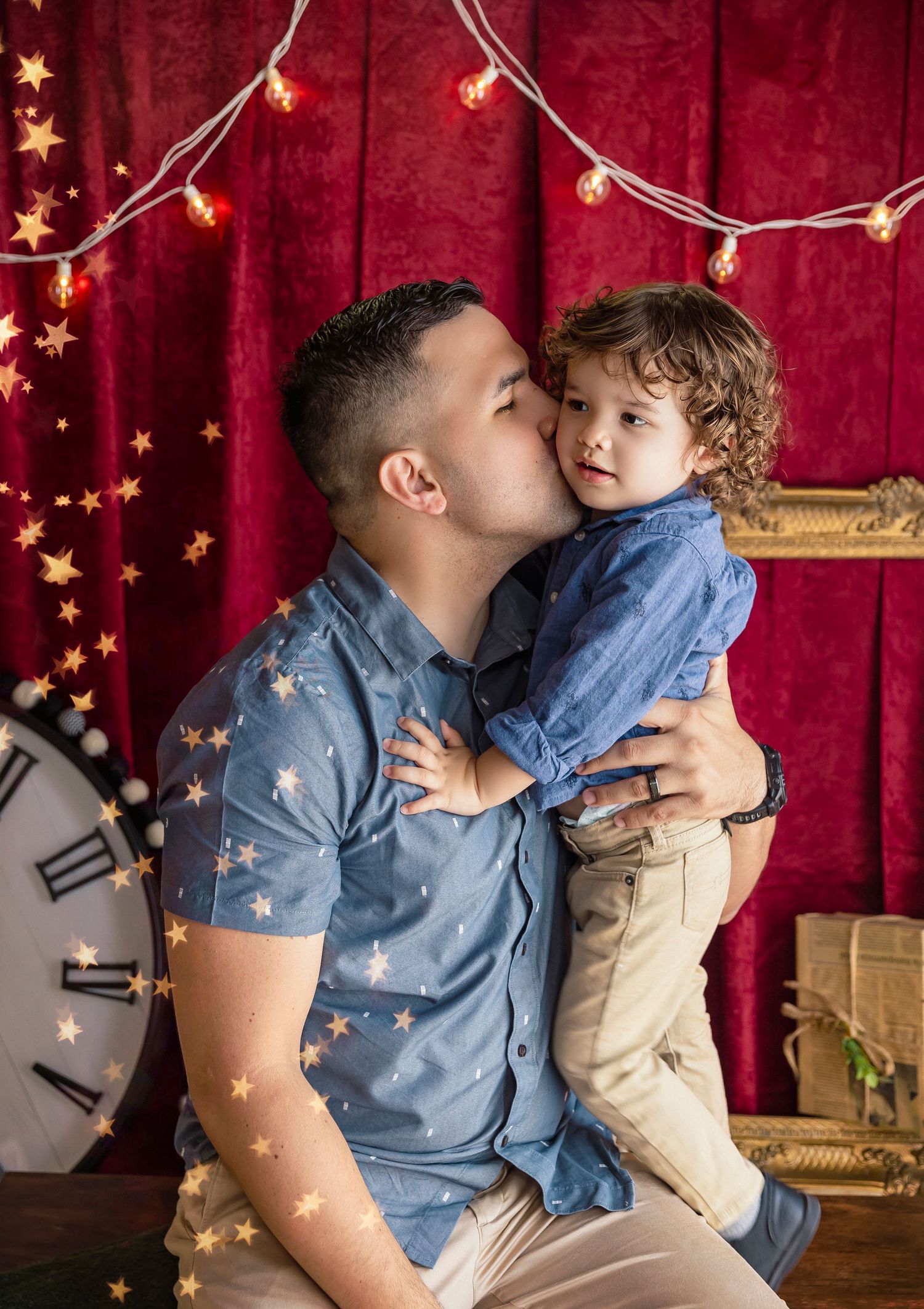 dad gives little boy a kiss on the cheek both dressed in denim