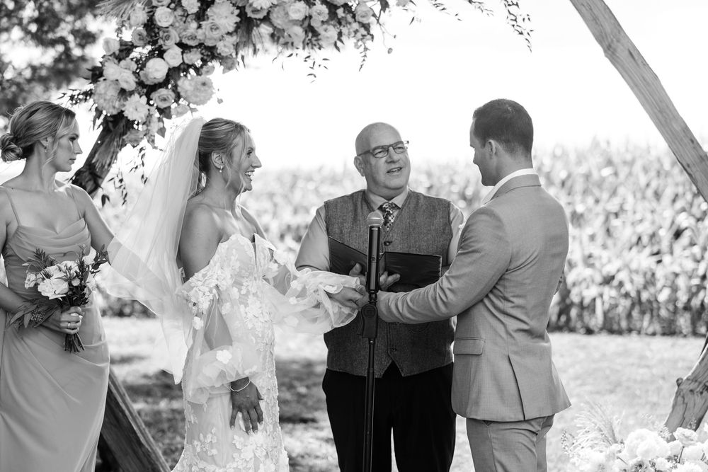 Black and white wedding photos showing couples exchanging vows under floral arches at outdoor ceremonies.