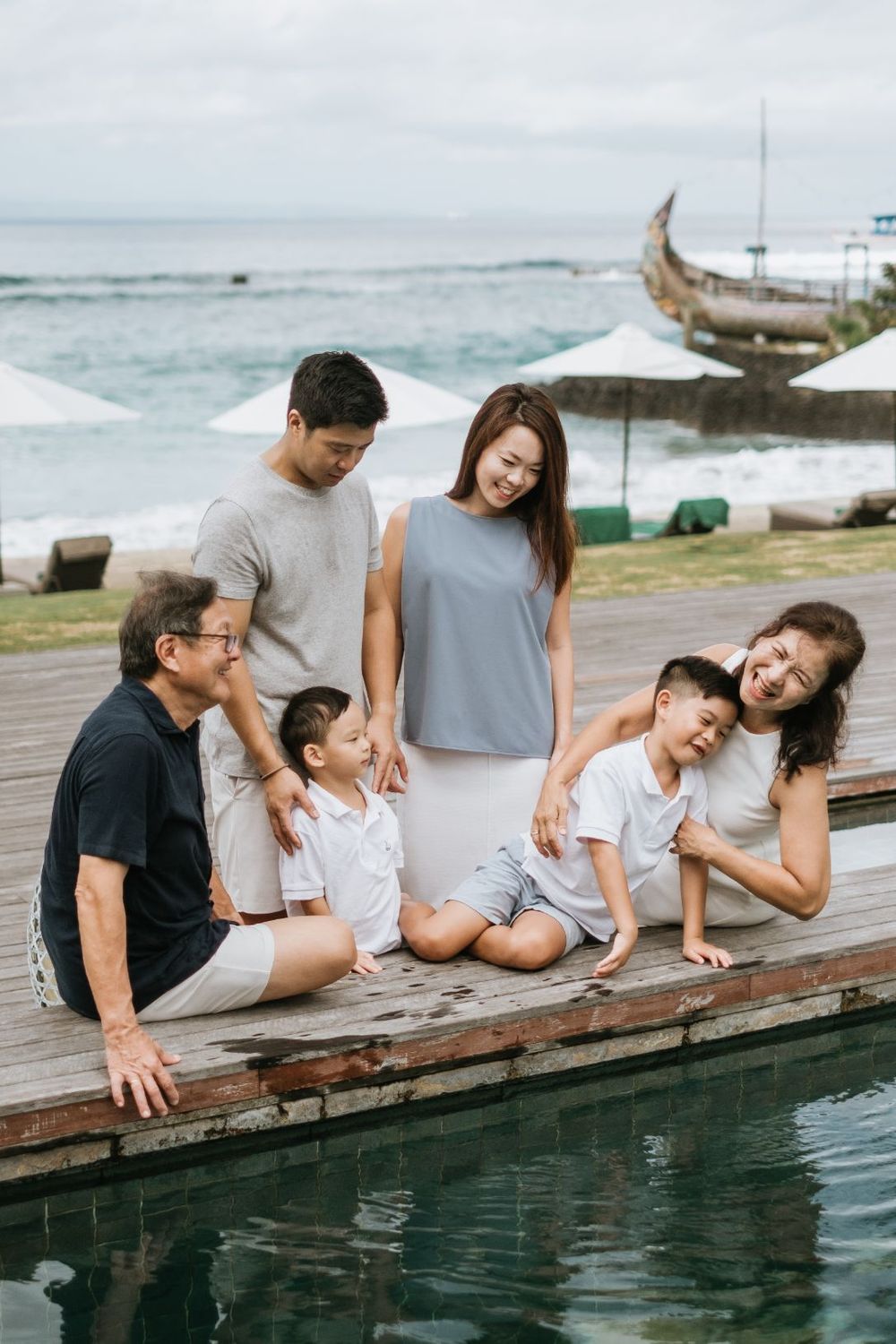 Beach family photography in Bali with an 
ocean backdrop