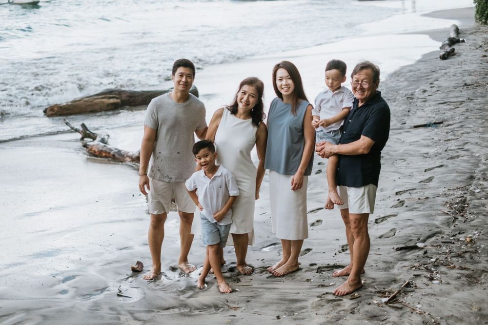 Beach family photography in Bali with an 
ocean backdrop