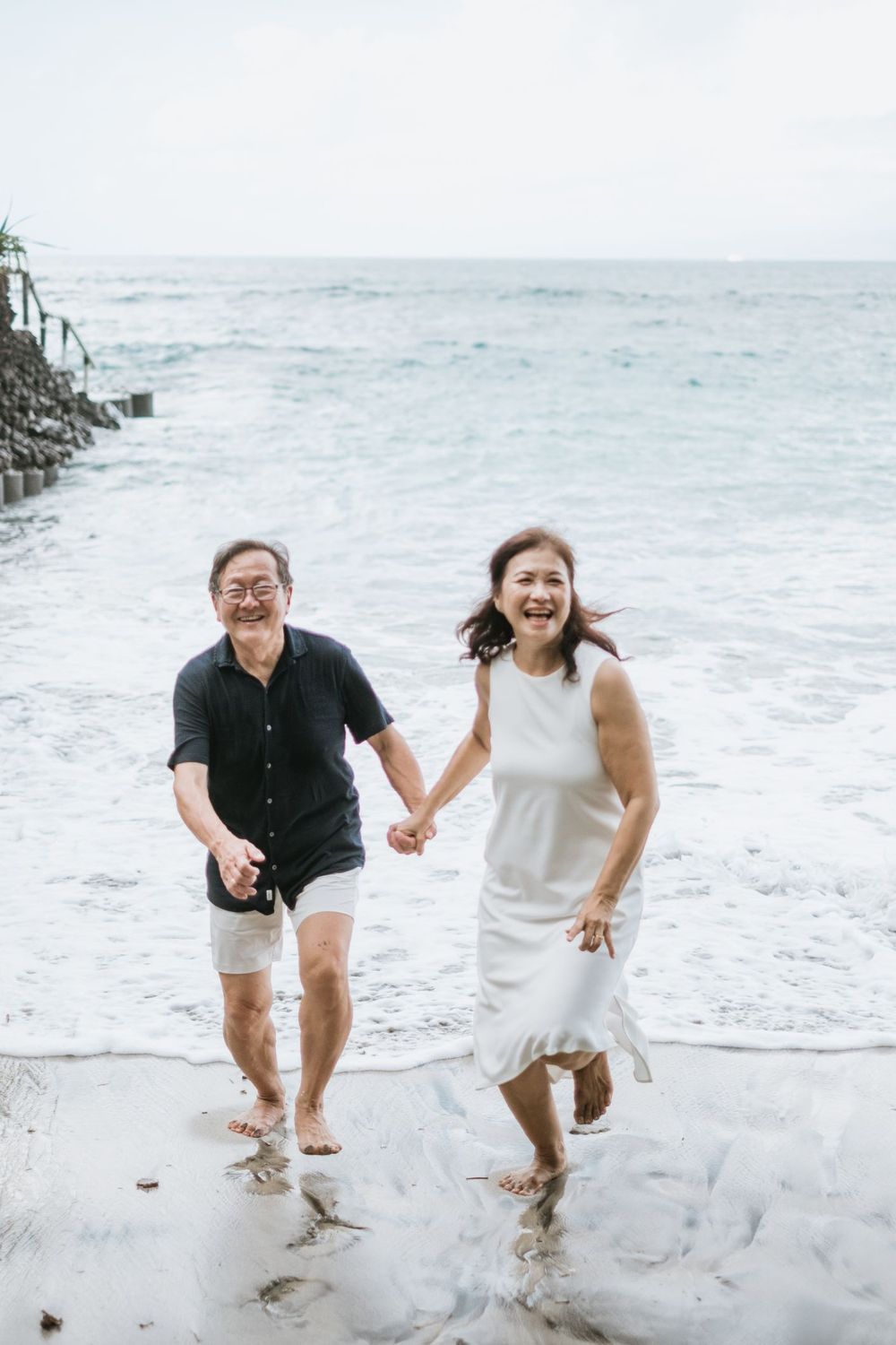Beach family photography in Bali with an 
ocean backdrop