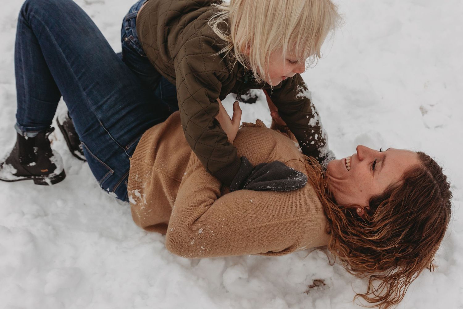 Playful moments captured in the snow with cozy winter attire.