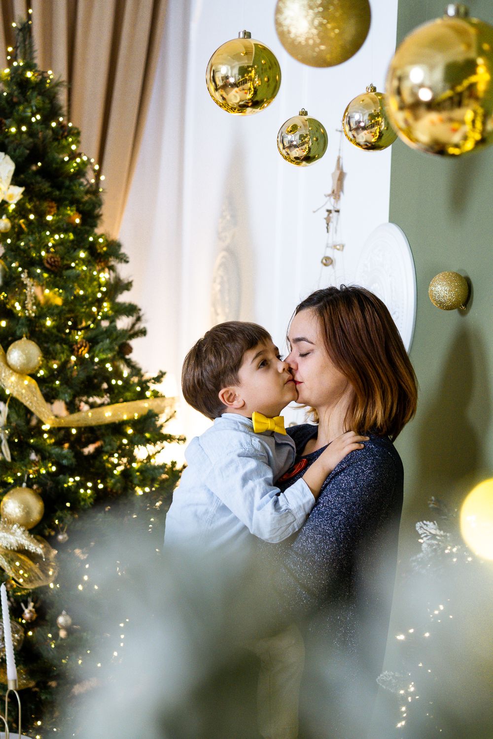 Christmas scene with gold ornaments and twinkling lights creating a festive atmosphere.