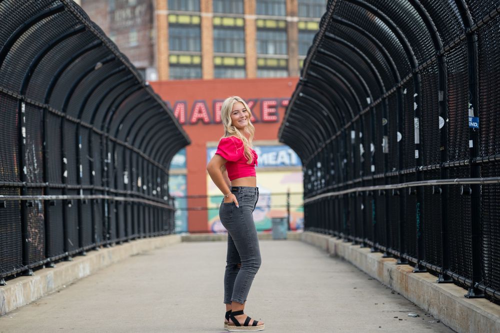 Long industrial bridge corridor with repeating metal arches and dramatic perspective.