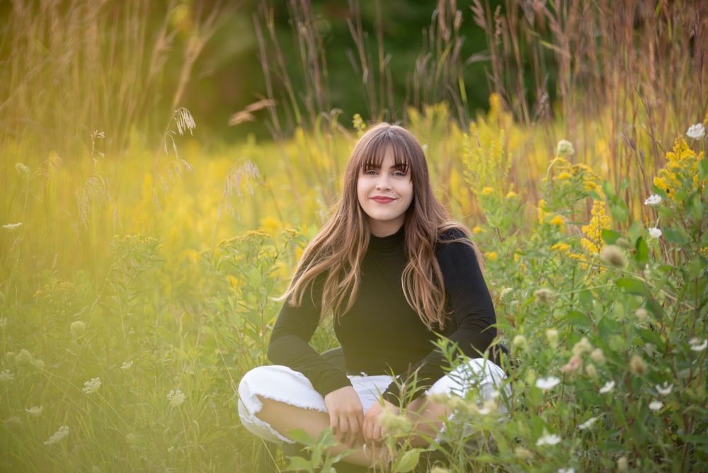 Portrait session in field of wildflowers during golden hour.