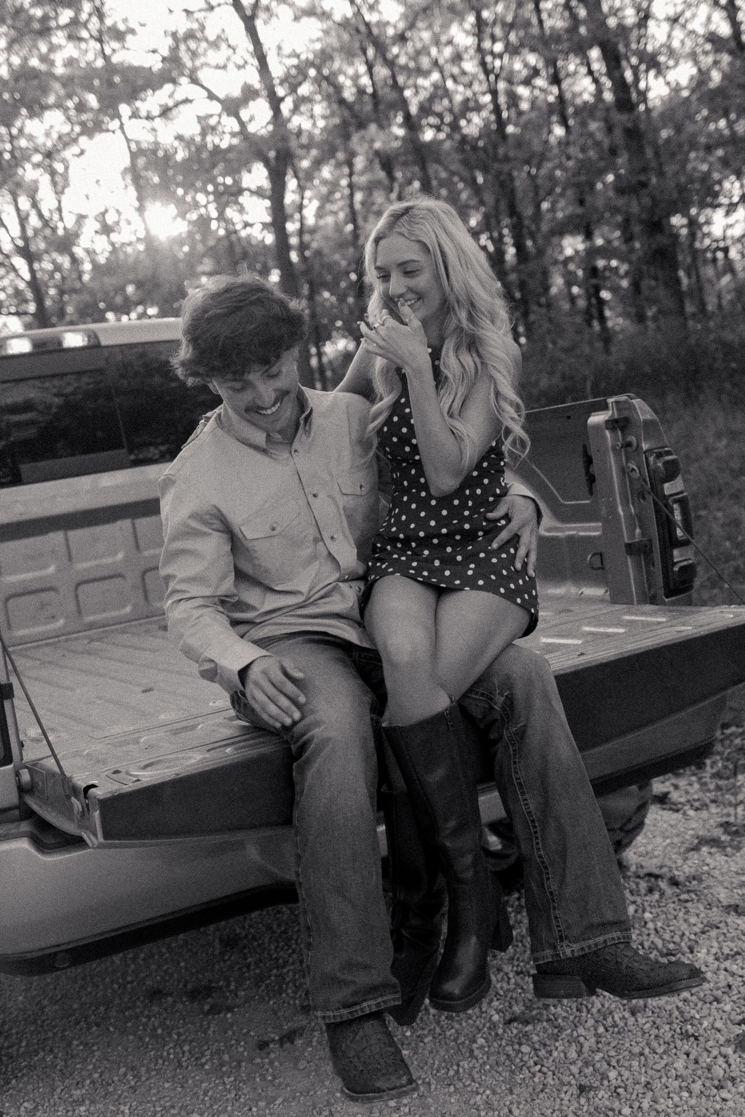 Black and white photo series showing a couple sitting together on a park bench in a romantic moment.
