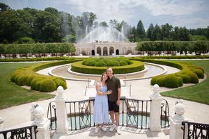 Couple posing in front of grand fountain and manicured gardens at Longwood Gardens, Pennsylvania.