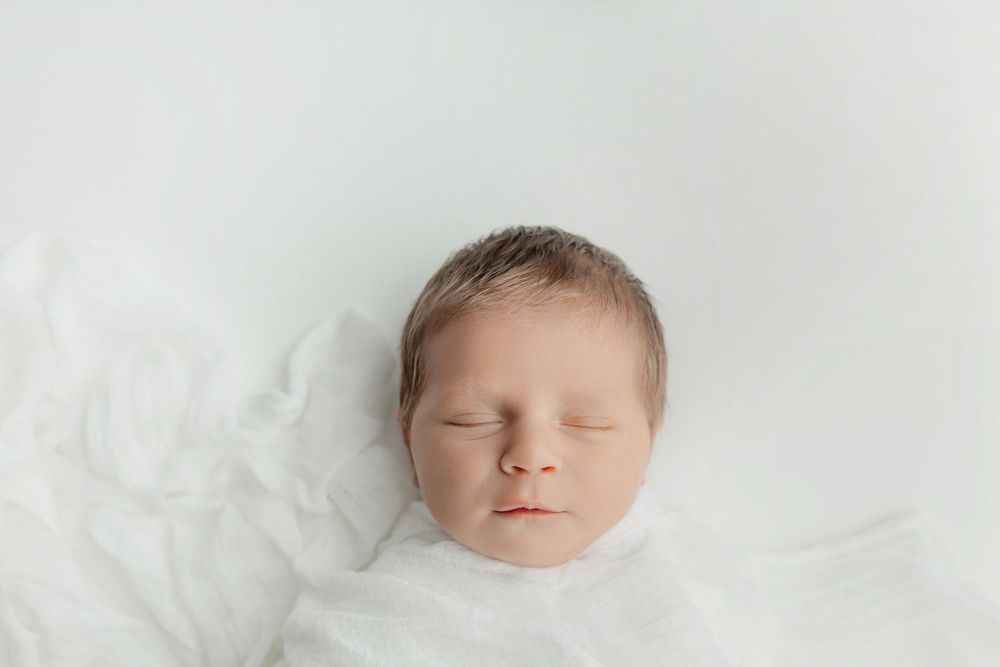 Newborn boy on white background, taken by Jen Knightstep, Photographer