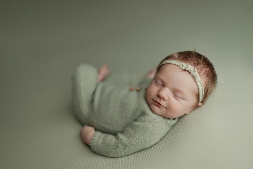 Newborn girl on sage green background, taken by Jen Knightstep, Photographer