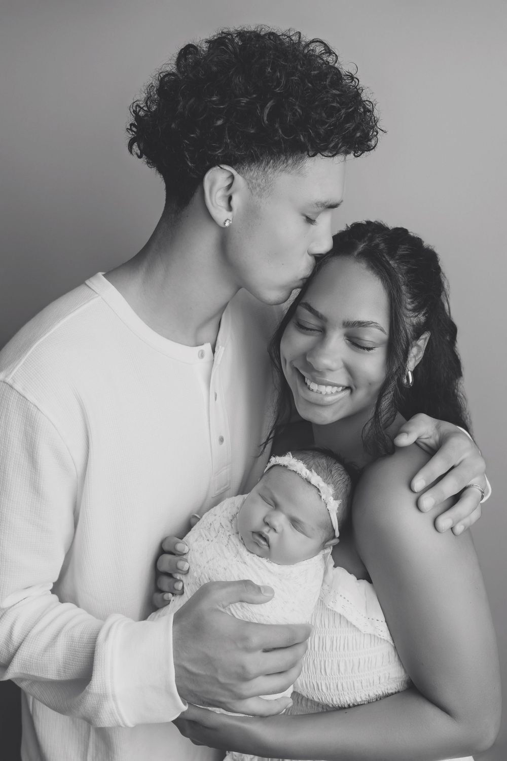 Mother, father and newborn baby all snuggled in Family Sandwich pose, taken by Jen Knightstep, Photographer